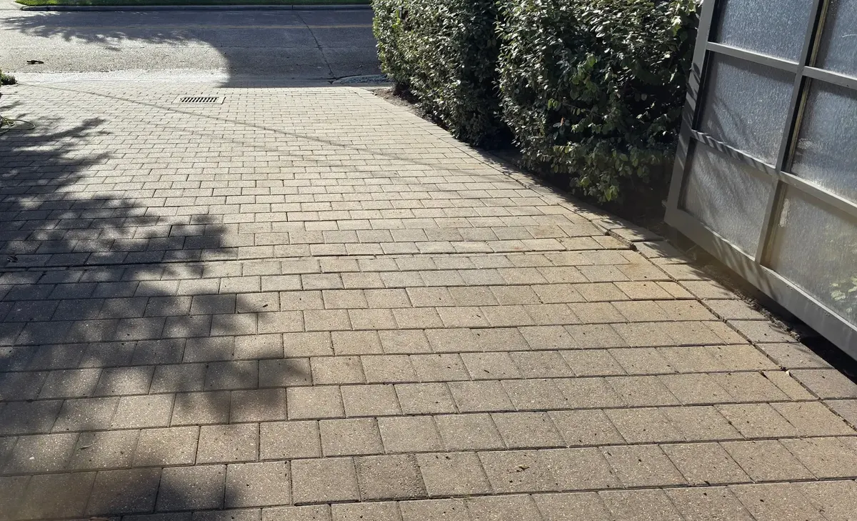 Paver driveway in Houston after hydraulic fluid was removed by Maddox Surface, looking toward the street